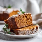 Close-up of pumpkin bread with cinnamon sugar topping, sliced to show moist crumb.