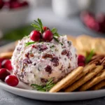 Cranberry pecan cream cheese spread topped with pecans on a holiday platter.