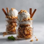 Mini apple crisps baked with oats and cinnamon, served warm in mason jars.