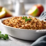 Vegan apple crisp baked with coconut oil and maple syrup, topped with golden oats.