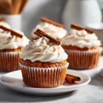 Moist Pumpkin Bread Cupcakes with Frosting on white plate, cozy fall dessert for easy pumpkin baking.