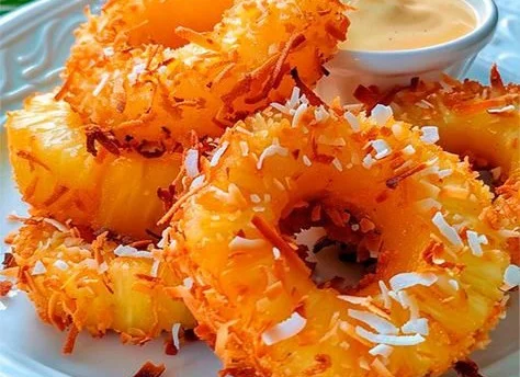Delicious rum-soaked fried pineapple dessert served on a plate