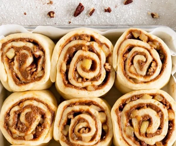 Soft-baked apple cinnamon rolls topped with icing and cinnamon