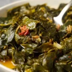 Bowl of authentic vegan collard greens garnished with herbs and spices