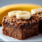 Delicious homemade banana bread brownies served on a white plate.