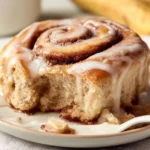 Delicious banana bread cinnamon rolls topped with creamy frosting.