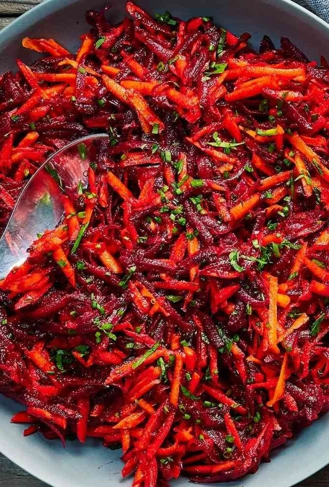 Fresh beet and carrot salad with a drizzle of vinaigrette