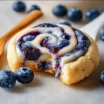 Delicious blueberry cheesecake swirl cookie with creamy filling and blueberry topping