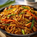 Delicious homemade Chicken Lo Mein served in a bowl with colorful vegetables.