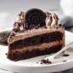 Delicious Chocolate Oreo Cake topped with crushed Oreos and chocolate frosting