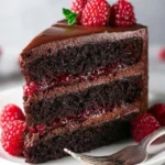 Delicious Chocolate Raspberry Layer Cake with rich chocolate layers and fresh raspberries