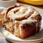 Freshly baked cinnamon roll banana bread with a cinnamon swirl topping