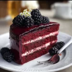 Decadent Blackberry Velvet Gothic Cake topped with fresh blackberries and cream