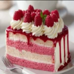 Delightful pink raspberry layer cake with layers of creamy frosting and berries