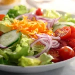 Fresh garden salad with mixed greens, tomatoes, cucumbers, and dressing