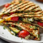 Grilled Mediterranean Veggie Quesadillas with colorful vegetables and herbs.