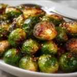 Plate of Honey Garlic Roasted Brussels Sprouts garnished for serving