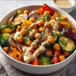 Roasted vegetable and chickpea bowl with vibrant colors and fresh ingredients.