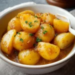 Bowl of Southern stewed potatoes served warm with herbs