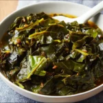 A bowl of vegan Southern-style collard greens seasoned with spices and ready to serve.