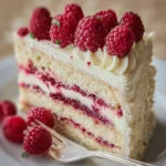 White Chocolate Raspberry Dream Cake 3 Slice of White Chocolate Raspberry Dream Cake with fresh raspberries on top