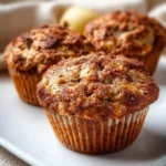 Apple Cinnamon Greek Yogurt Muffins 3 Delicious Apple Cinnamon Greek Yogurt Muffins on a wooden table