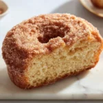 Loaf of cinnamon sugar donut bread with a golden brown crust.