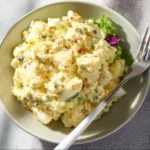 Cottage Cheese Egg Salad 2 Bowl of cottage cheese egg salad garnished with herbs on a wooden table