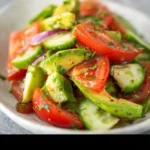 Refreshing Cucumber Tomato Avocado Salad in a bowl with fresh ingredients