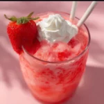 Strawberry Cream Soda 3 Glass of strawberry cream soda with fresh strawberries and whipped cream.