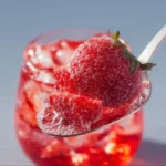Strawberry Dirty Sprite cocktail served in a glass with fresh strawberries