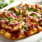 BBQ chicken flatbread topped with grilled chicken, sauce, and fresh ingredients