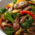 Beef stir fry with colorful vegetables in a wok