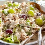 Chicken Salad with Grapes 4 Delicious chicken salad with grapes, fresh herbs, and creamy dressing in a bowl.