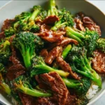 A plate of Chinese Beef and Broccoli featuring tender beef and fresh broccoli in a savory sauce.