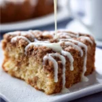 Delicious homemade coffee cake served slice on a plate with a cup of coffee