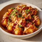 Crispy Air Fryer Bang Bang Chicken served on a plate with dipping sauce.