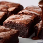 Greek Yogurt Brownies 4 Deliciously rich Greek yogurt brownies on a wooden table