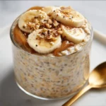 Healthy Banana Bread Overnight Oats 4 Bowl of healthy banana bread overnight oats topped with slices of banana and nuts