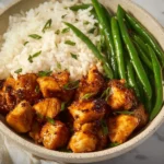 Honey Garlic Chicken Bites 4 Delicious Honey Garlic Chicken Bites served on a platter with garnish