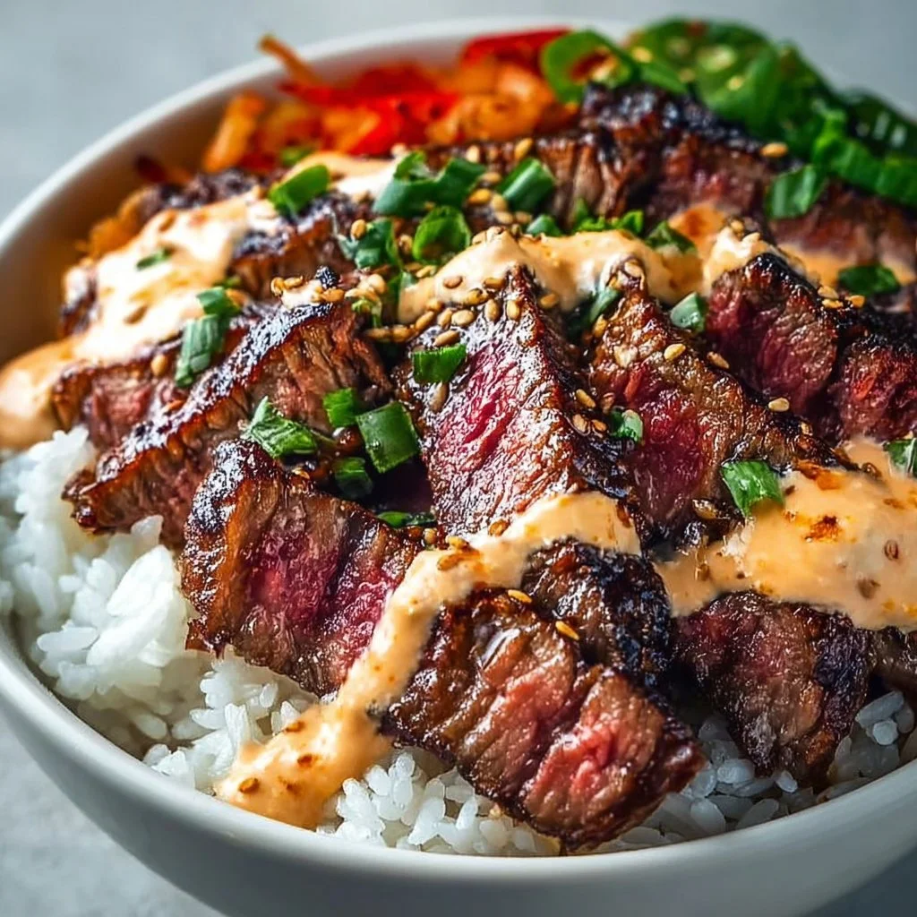 Korean BBQ steak rice bowl topped with vegetables and sesame seeds