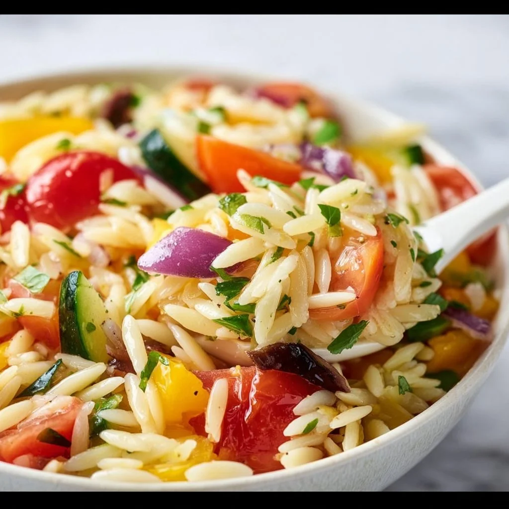 Delicious orzo salad with fresh vegetables and dressing