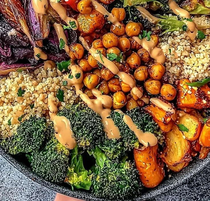 Delicious roasted veggie chickpea bowls garnished with fresh herbs and spices.