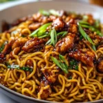 Plate of Sticky Garlic Chicken Noodles with vibrant vegetables