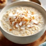 Bowl of tasty coconut cream oats topped with fresh fruits and nuts