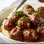 Slow cooker Salisbury steak meatballs served with gravy and mashed potatoes