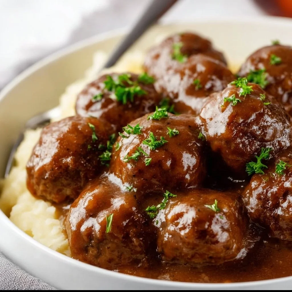 Slow cooker Salisbury steak meatballs served with gravy and mashed potatoes