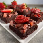 Delicious Chocolate Covered Strawberry Brownies topped with fresh strawberries.