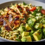 Grilled Chicken Orzo Salad with Avocado served in a bowl