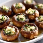 Plate of delicious roasted garlic butter mushrooms garnished with herbs